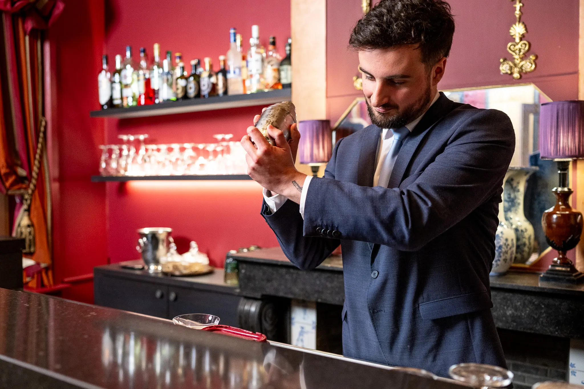 Bartender making homemade cocktail in the bar of Hotel De Castillion