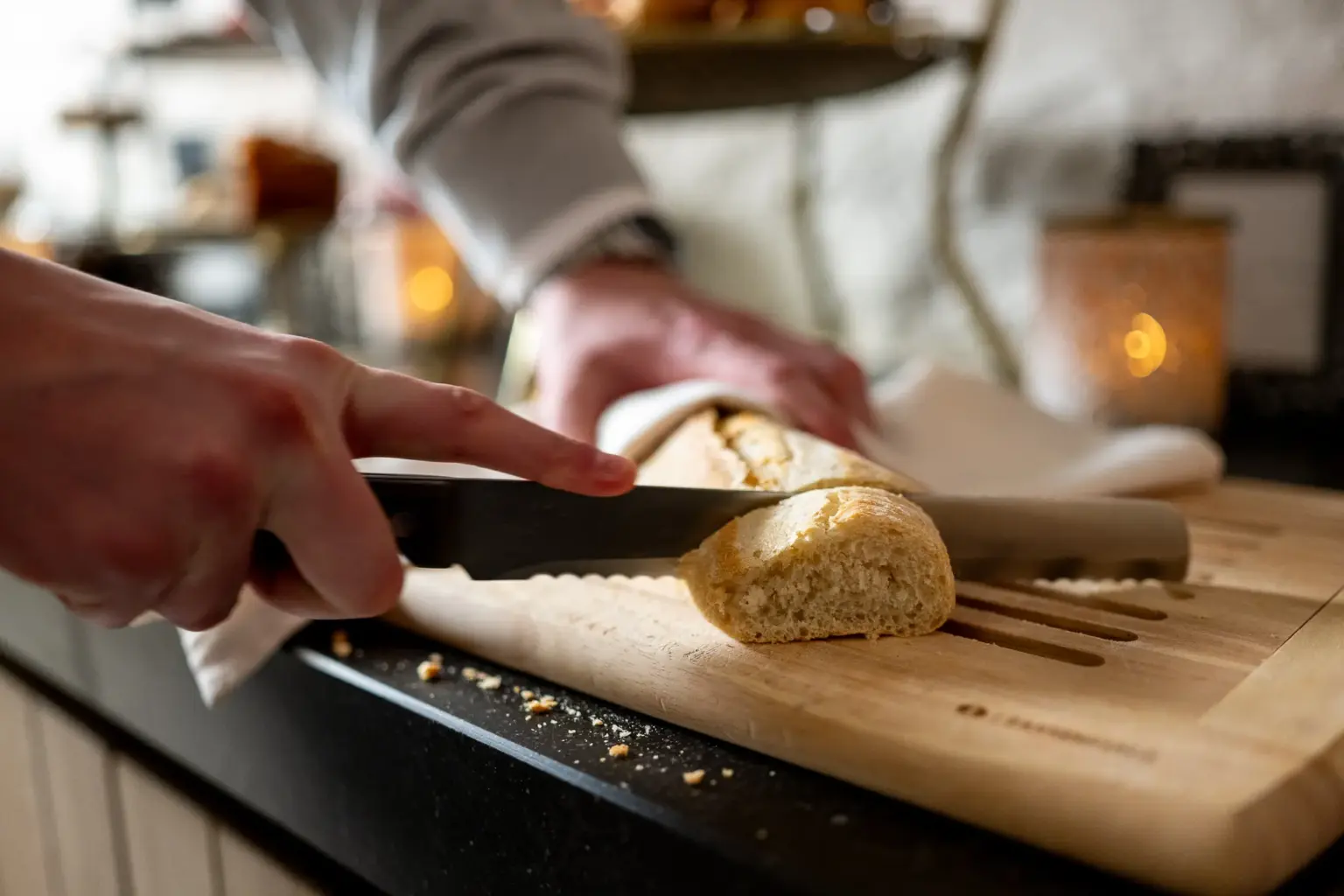 Cutting fresh baguette at Hotel de Castillion's breakfast buffet