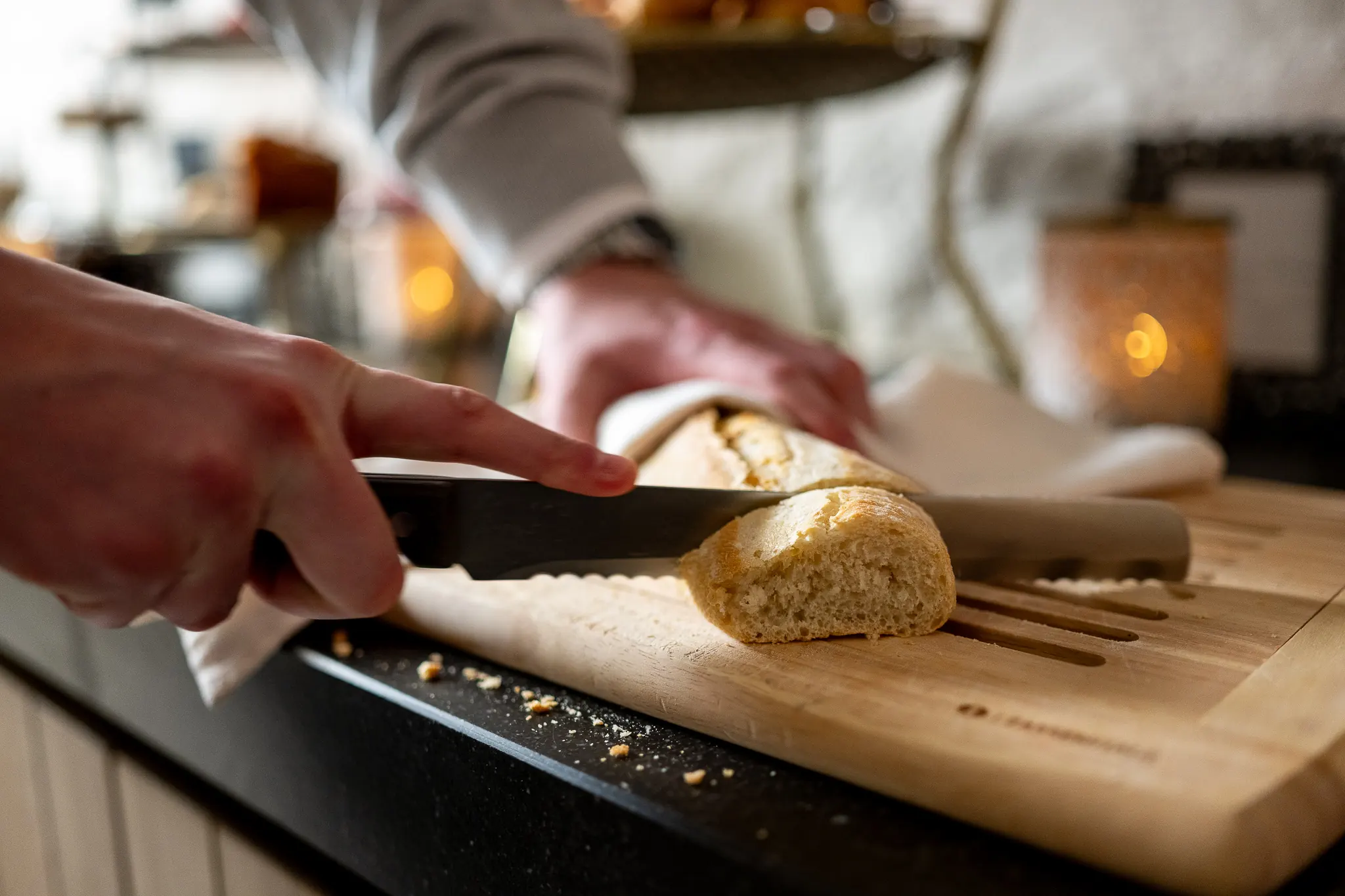 Cutting fresh baguette at Hotel de Castillion's breakfast buffet